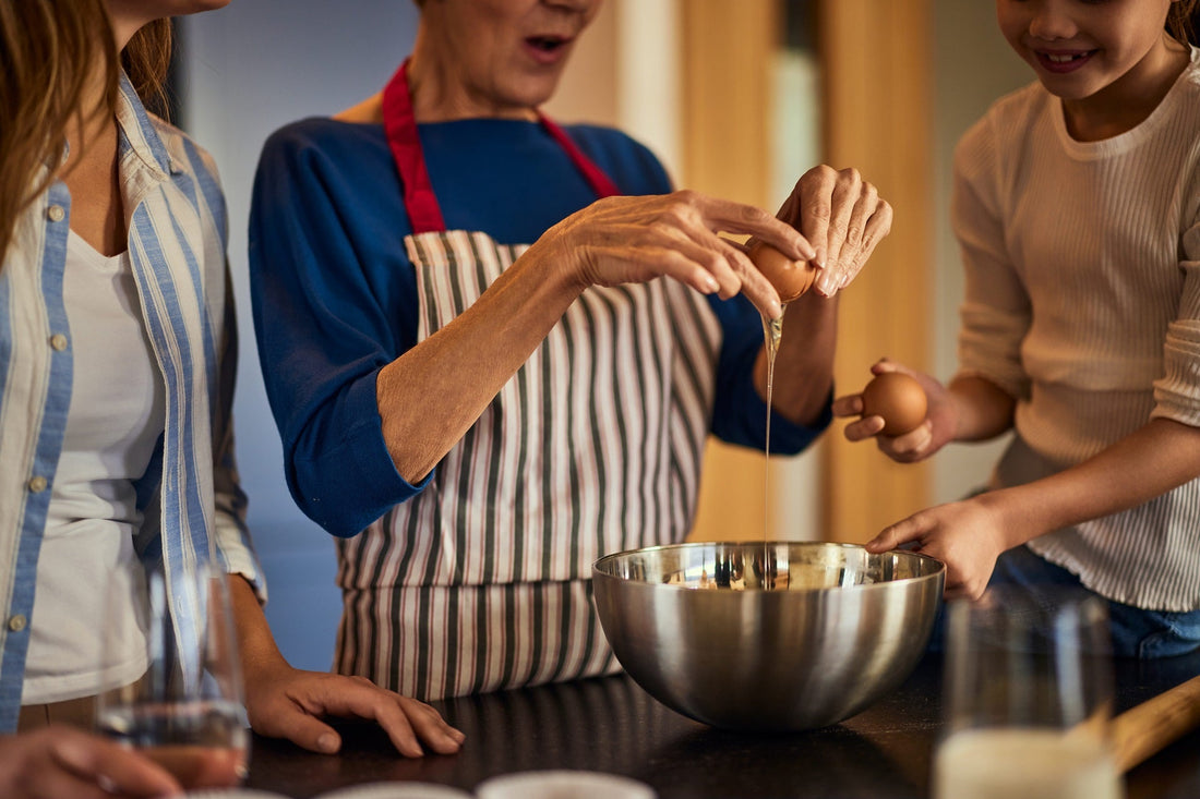 Fun cooking classes for kids and families enjoying egg cracking together, School holiday cooking classes