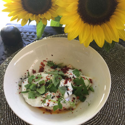 Perfectly poached eggs with chilli, basil and black salt bling.